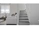 Bright staircase with white walls and grey-toned steps, connecting the living space with natural light at 15160 Avenue Of The Arbors, Winter Garden, FL 34787