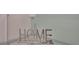 Silver 'HOME' decor displayed on a glass corner shelf at 1557 Sandbagger Dr, Davenport, FL 33896