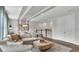Cozy living room with plush sectional sofa, coffered ceiling, and modern decor at 161 Purcell Dr, Alafaya, FL 32825
