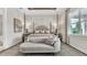 Elegant main bedroom with a four-poster bed, chaise lounge, and sophisticated decor at 161 Purcell Dr, Alafaya, FL 32825