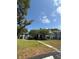 Three-story condo building with blue siding, mature trees, and well-maintained landscaping at 2585 Grassy Point Dr # 313, Lake Mary, FL 32746
