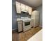 Kitchen featuring white appliances, tile flooring, and ample cabinet space at 2585 Grassy Point Dr # 313, Lake Mary, FL 32746