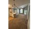 Open-concept living space combining the kitchen and living room with high ceilings and natural light at 2585 Grassy Point Dr # 313, Lake Mary, FL 32746