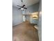 Open concept living room with high ceilings, ceiling fan, and view of the kitchen at 2585 Grassy Point Dr # 313, Lake Mary, FL 32746