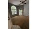 Spacious living room featuring a large arched window, sliding door to balcony, and ceiling fan at 2585 Grassy Point Dr # 313, Lake Mary, FL 32746