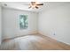 Relaxing bedroom boasts wood floors, natural light, and a ceiling fan at 2907 Southern Pines Loop, Clermont, FL 34711