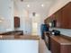 This spacious kitchen has stone countertops, wooden cabinetry, and modern appliances at 2907 Southern Pines Loop, Clermont, FL 34711