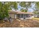 Backyard featuring covered porch and mature trees at 3 Spring Lane Way, Ocala, FL 34472