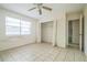 Spacious bedroom featuring tiled floors, closet, and ceiling fan at 3 Spring Lane Way, Ocala, FL 34472