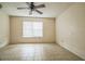 Bedroom with tiled floor, ceiling fan, and window overlooking the backyard at 3 Spring Lane Way, Ocala, FL 34472