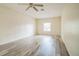Bedroom with laminate wood floor, ceiling fan, and window at 3 Spring Lane Way, Ocala, FL 34472