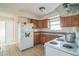 Kitchen featuring a white refrigerator and tile floors at 3 Spring Lane Way, Ocala, FL 34472