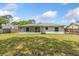 Charming home featuring a screened porch and fenced backyard, offering privacy and relaxation at 3111 Pine Tree Dr, Edgewater, FL 32141