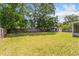 Expansive backyard featuring a lush green lawn and a storage shed, perfect for outdoor activities at 3111 Pine Tree Dr, Edgewater, FL 32141