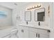 A well-lit bathroom includes double vanity, framed mirrors, tiled shower with tub, and storage at 3111 Pine Tree Dr, Edgewater, FL 32141