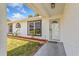 Inviting front entrance with a well-kept lawn, mulch landscaping, and stylish modern window trim at 3111 Pine Tree Dr, Edgewater, FL 32141