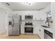Well-appointed kitchen featuring stainless steel appliances, white cabinets, and modern fixtures at 3111 Pine Tree Dr, Edgewater, FL 32141