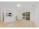 Bright living space with a skylight and view into the kitchen and sliding doors to an outdoor area at 3111 Pine Tree Dr, Edgewater, FL 32141