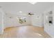Bright, open living room with light wood floors and modern wall sconces at 3111 Pine Tree Dr, Edgewater, FL 32141
