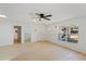 Spacious living room with light wood floors, a ceiling fan, and views of the front yard at 3111 Pine Tree Dr, Edgewater, FL 32141