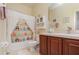 Bathroom features a shower with a colorful owl curtain and dark wood vanity at 3321 San Jacinto Cir # 116, Sanford, FL 32771
