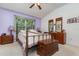 Bedroom with a vaulted ceiling, brass bed, and purple accent wall at 3321 San Jacinto Cir # 116, Sanford, FL 32771
