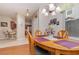 Open dining room featuring a wooden table, chandelier lighting, and adjacent kitchen view at 3321 San Jacinto Cir # 116, Sanford, FL 32771