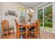 Cozy dining area with a wooden table, seating for four, and sliding glass doors to the outdoors at 3321 San Jacinto Cir # 116, Sanford, FL 32771