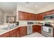 Well-lit kitchen featuring stainless steel appliances and dark wood cabinetry at 3321 San Jacinto Cir # 116, Sanford, FL 32771