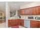 Open-concept kitchen with stainless steel appliances and wood cabinets at 3321 San Jacinto Cir # 116, Sanford, FL 32771