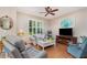 Comfortable living room with ceiling fan, large window with plantation shutters, and cozy furnishings at 3321 San Jacinto Cir # 116, Sanford, FL 32771