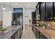 Contemporary kitchen featuring dark cabinets, stainless appliances, granite counters, and mosaic backsplash at 3716 Paradiso Cir, Kissimmee, FL 34746