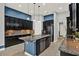 Open kitchen featuring dark cabinets, granite countertops, stainless appliances, and kitchen island with barstools at 3716 Paradiso Cir, Kissimmee, FL 34746
