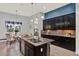 Spacious kitchen featuring dark cabinets, granite counters, central island, and pendant lighting at 3716 Paradiso Cir, Kissimmee, FL 34746