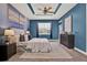 Serene main bedroom with blue accent wall, tray ceiling, soft lighting, and neutral decor at 3716 Paradiso Cir, Kissimmee, FL 34746