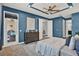 Bright main bedroom with blue walls, ceiling fan, dresser, and access to the patio and closet at 3716 Paradiso Cir, Kissimmee, FL 34746
