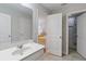 Bathroom with a white vanity sink and views into the bedroom and bathroom at 4201 Oakview Dr, Davenport, FL 33837