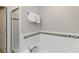 This bathroom features a tiled tub, glass shower doors, and a hand towel rack at 4201 Oakview Dr, Davenport, FL 33837