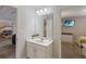 This bathroom features one sink, a mirror and two doors to adjacent bedrooms at 4201 Oakview Dr, Davenport, FL 33837