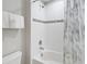 Bathroom with a white shower and tub combo with white tile and towel rack at 4201 Oakview Dr, Davenport, FL 33837