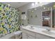 Bright bathroom featuring double sinks and a lemon themed shower curtain at 4201 Oakview Dr, Davenport, FL 33837