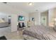 Bedroom with a TV, dresser, mirror, neutral decor, and views into the kitchen and living area at 4201 Oakview Dr, Davenport, FL 33837