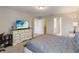 A bedroom featuring a large dresser and television with two doors leading to a closet and bathroom at 4201 Oakview Dr, Davenport, FL 33837