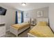 A bedroom with two twin beds with yellow patterned bedding and a flatscreen television at 4201 Oakview Dr, Davenport, FL 33837
