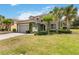 Charming two-story home with a tile roof and lush landscaping featuring mature palm trees at 4201 Oakview Dr, Davenport, FL 33837