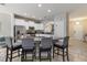 Kitchen with granite countertops, white cabinetry, an island, and seating for four at the breakfast bar at 4201 Oakview Dr, Davenport, FL 33837