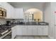 Bright kitchen features granite counters, white cabinets, and breakfast bar with views into dining room at 4201 Oakview Dr, Davenport, FL 33837