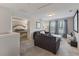 Comfortable living room with gray couches, natural lighting, and view into adjacent bedroom at 4201 Oakview Dr, Davenport, FL 33837
