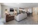 Open-concept living area with tile flooring, comfortable seating, and a view into the kitchen at 4201 Oakview Dr, Davenport, FL 33837