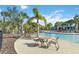 Resort-style community pool with a lazy river, palm trees, and comfortable seating areas at 4201 Oakview Dr, Davenport, FL 33837